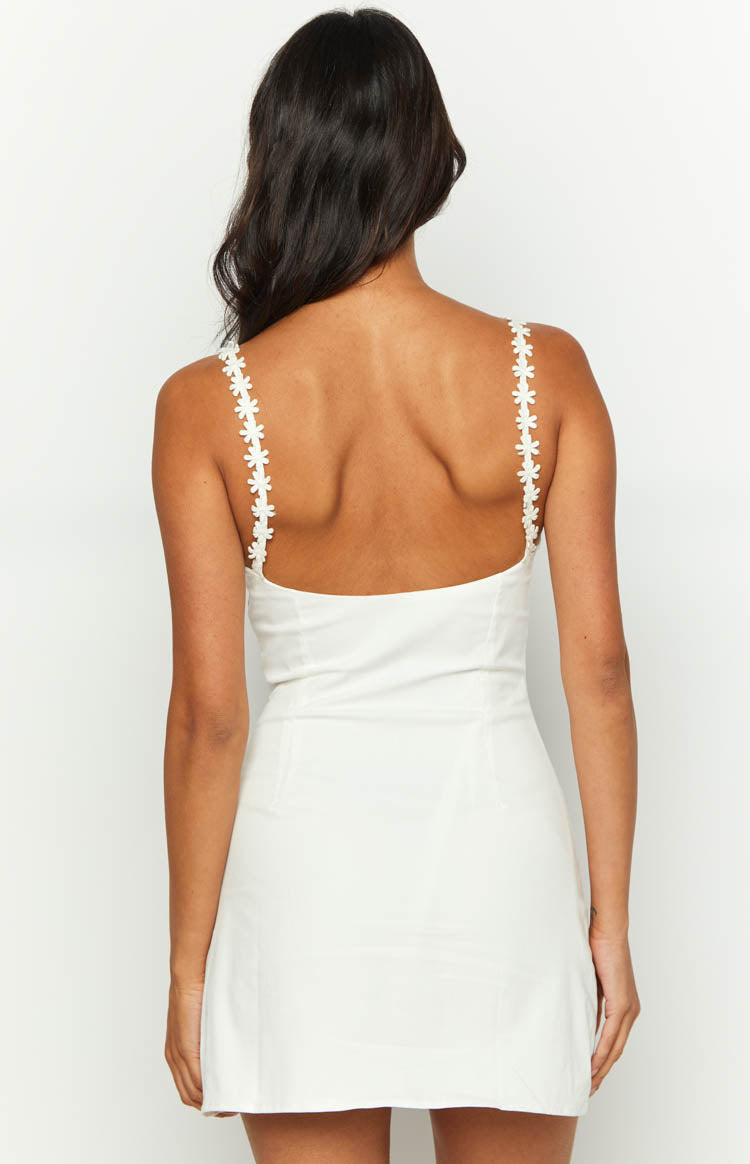 Rear view of a white mini dress with a low scoop back and daisy-chain shoulder straps