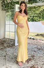 yellow satin midi dress on Leah Halton in courtyard