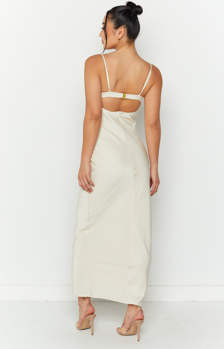 Rear view of a cream midi dress with thin spaghetti straps, a gold back clasp, and a cutout
