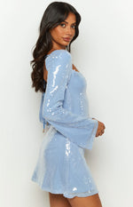 Side view of a blue sequin mini dress with long flared sleeves and a square neckline