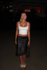 Black satin midi skirt with a subtle A-line silhouette and delicate lace trim at the hem