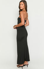 Side view of a black strapless maxi dress with a fitted silhouette and subtle side ruching