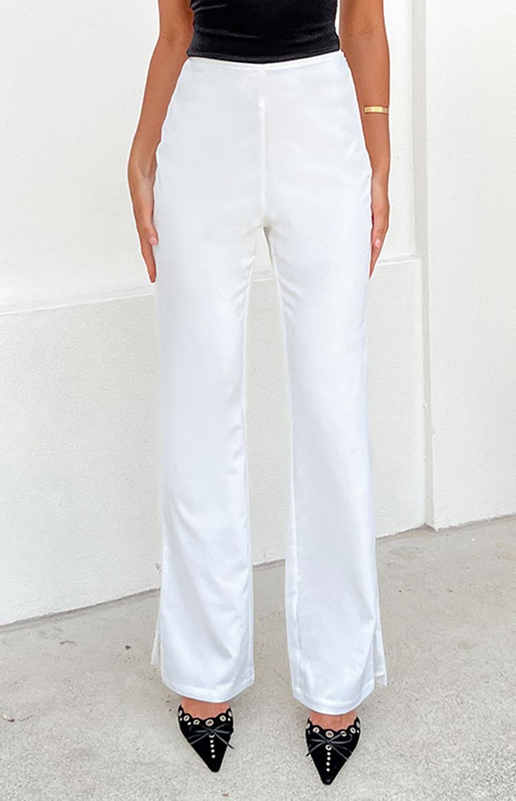 Full length view of white wide-leg pants with a subtle front seam and small side slits at the ankle