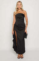 blonde model wearing black maxi dress with side ruffle