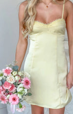 Yellow satin mini dress bodice with delicate lace trim, thin spaghetti straps, and fitted paneling