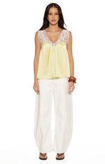 Yellow satin top with white lace trim on the V-neckline and shoulder straps, featuring a relaxed flowy fit