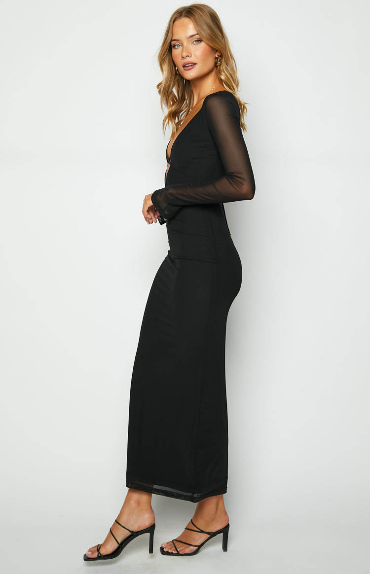 Side view of a black maxi dress with sheer mesh long sleeves, a fitted silhouette, and sheer hem detail