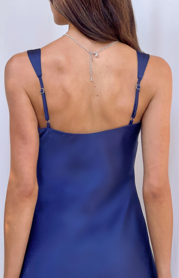 Rear view of a navy satin mini dress with a straight back neckline and thin adjustable spaghetti straps