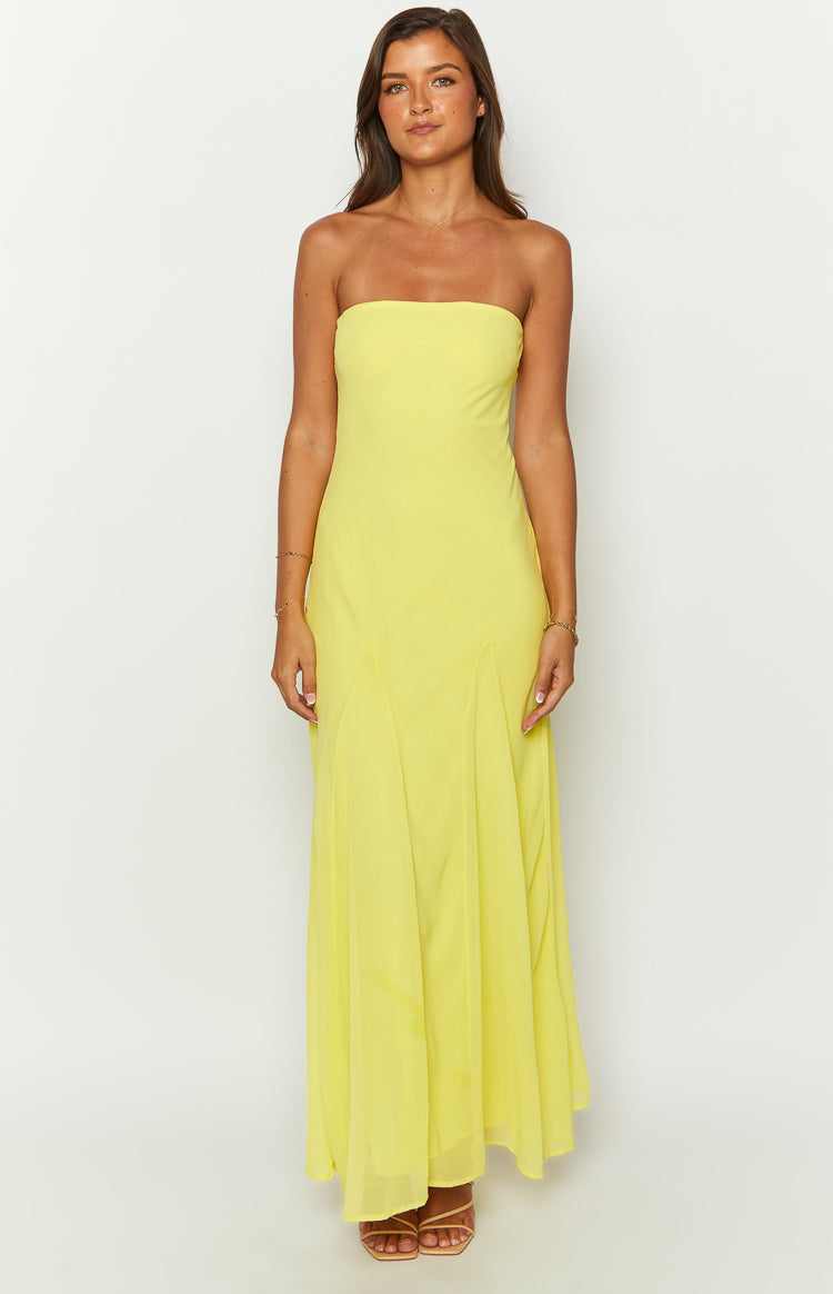 Front view of a bright yellow strapless maxi dress with a straight neckline and a flowy panelled skirt