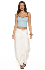 Light blue cropped tank top with red contrast trim on the scoop neckline and spaghetti straps