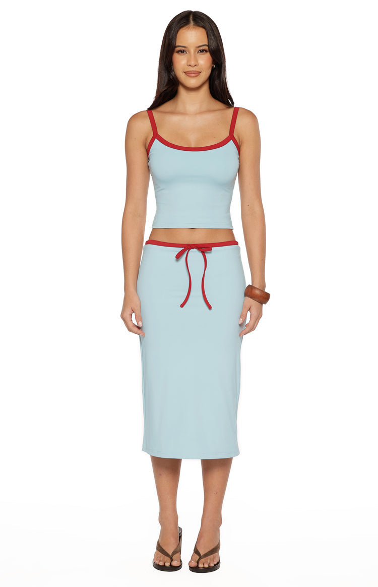 Full front view of a light blue cropped tank top with red trim on the scoop neck and spaghetti straps