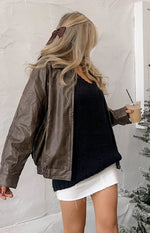 Side view of a black chunky knit sweater with a V-neckline and relaxed fit