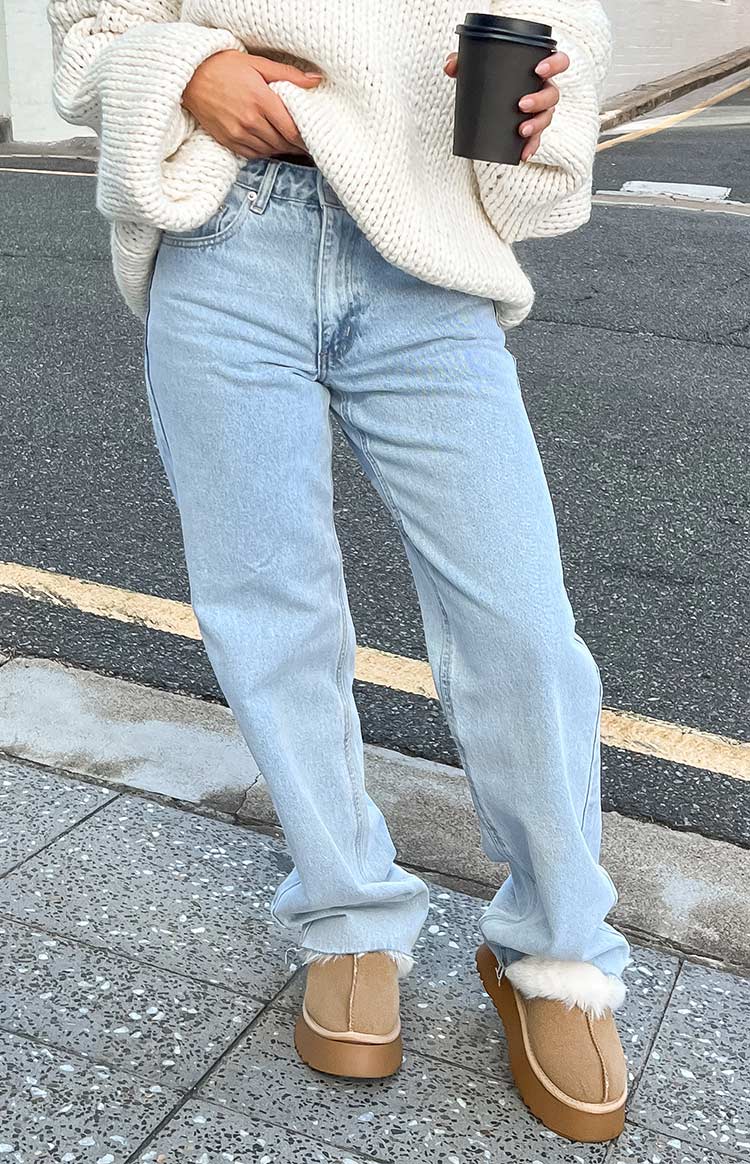 Full length view of light blue wide-leg jeans with a relaxed fit, light wash denim, and a slightly bunched hem