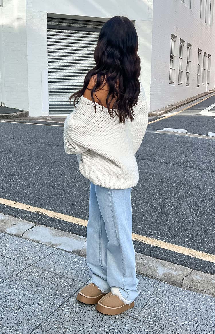 Side view of light blue wide-leg jeans with a relaxed fit and frayed hem