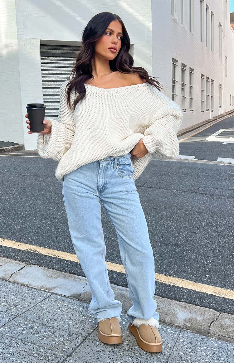 Light blue straight-leg jeans with a relaxed fit and an uneven high-rise waistline