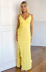 Full length view of a yellow ruffle maxi dress with a V-neck, spaghetti straps, and a high side slit
