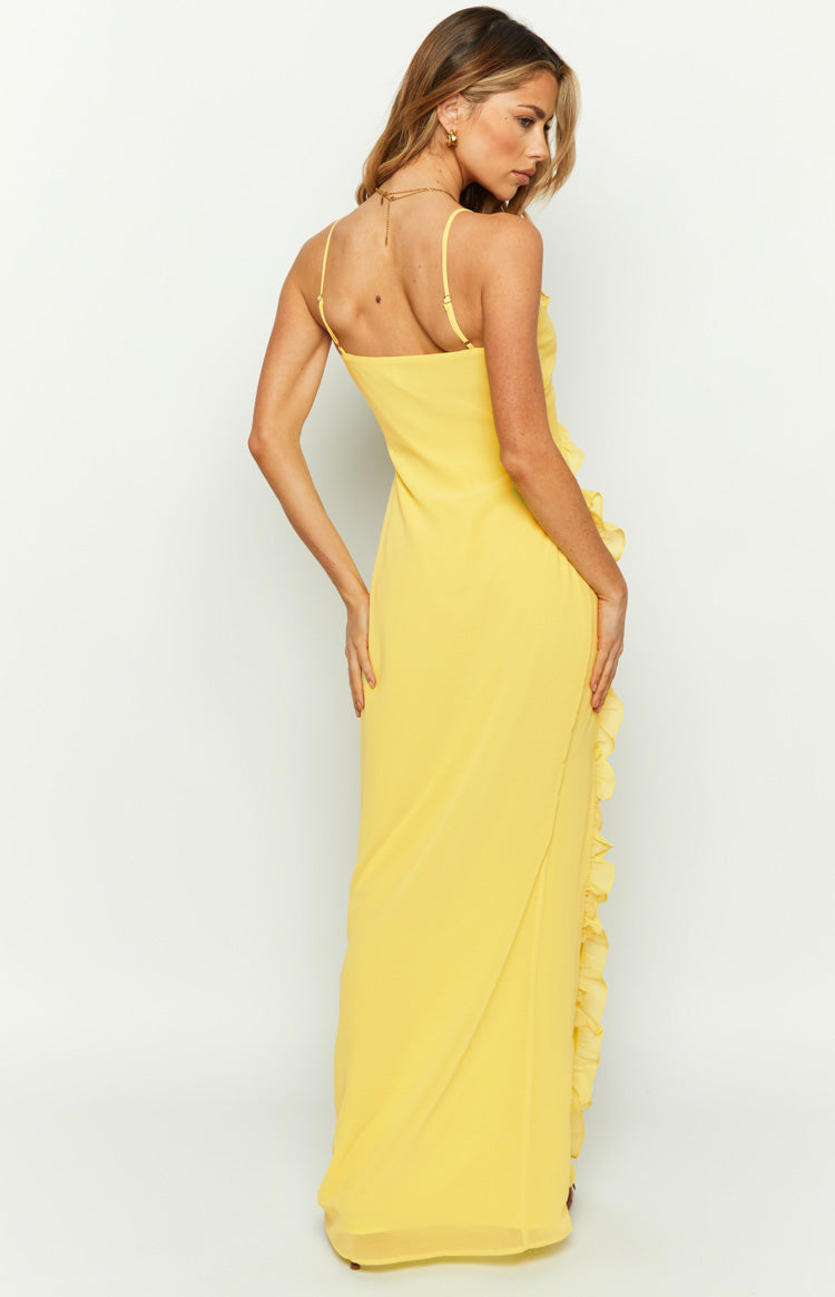 Close-up of the yellow maxi dress showing the ruffle trim on the V-neckline and side seam