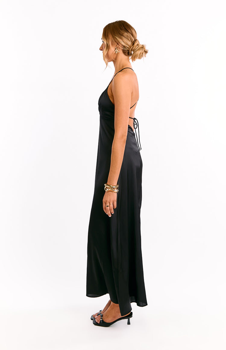 Side view of a black satin maxi dress with a V-neck, thin spaghetti straps, and a criss-cross tie-back
