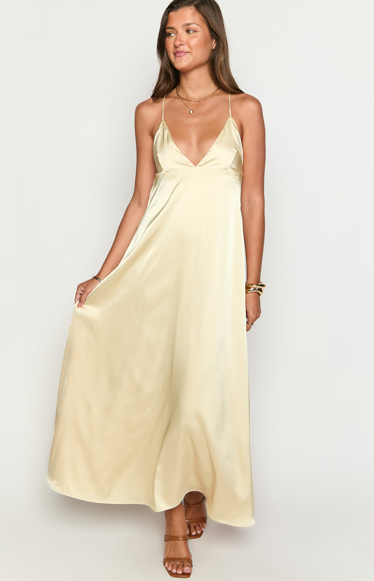 Yellow satin maxi dress with a deep V-neckline, thin spaghetti straps, and a flowing A-line skirt