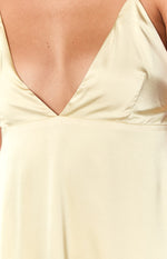 Close-up showing the deep V-neck and the matte, slightly textured yellow fabric of the maxi dress
