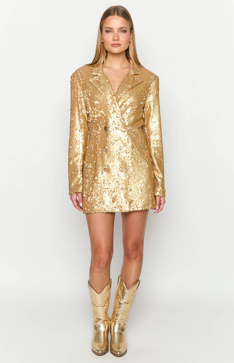 Front view of a gold sequin double-breasted blazer mini dress with lapels and long sleeves