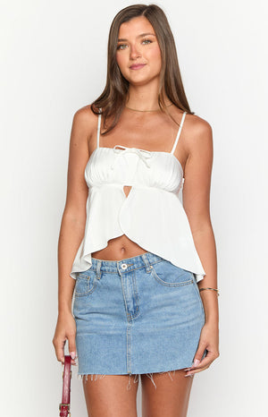 White square neck top with ruched bust, front tie, underbust cutout, and petal-shaped peplum hem