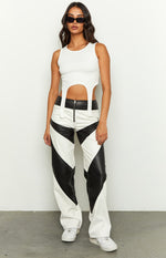 White PU wide-leg pants with black geometric contrast panels and a front zipper