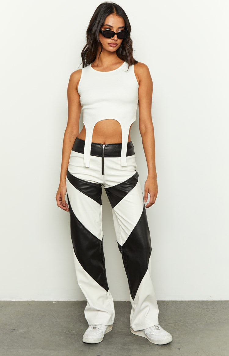Full length view of white and black PU contrast pants with chevron pattern and front zipper