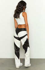 Rear view of white and black PU contrast pants showing the geometric paneling and straight leg fit