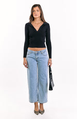 Black ribbed knit long sleeve sweater with a V-neck collar and a cropped hemline