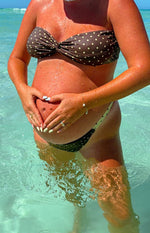 Brown polka dot strapless bikini top with twisted front and matching bikini bottom