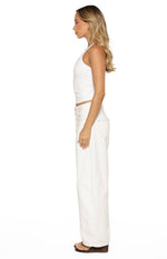 Side view of a white jersey halter neck top showing the fitted cropped length and thin straps