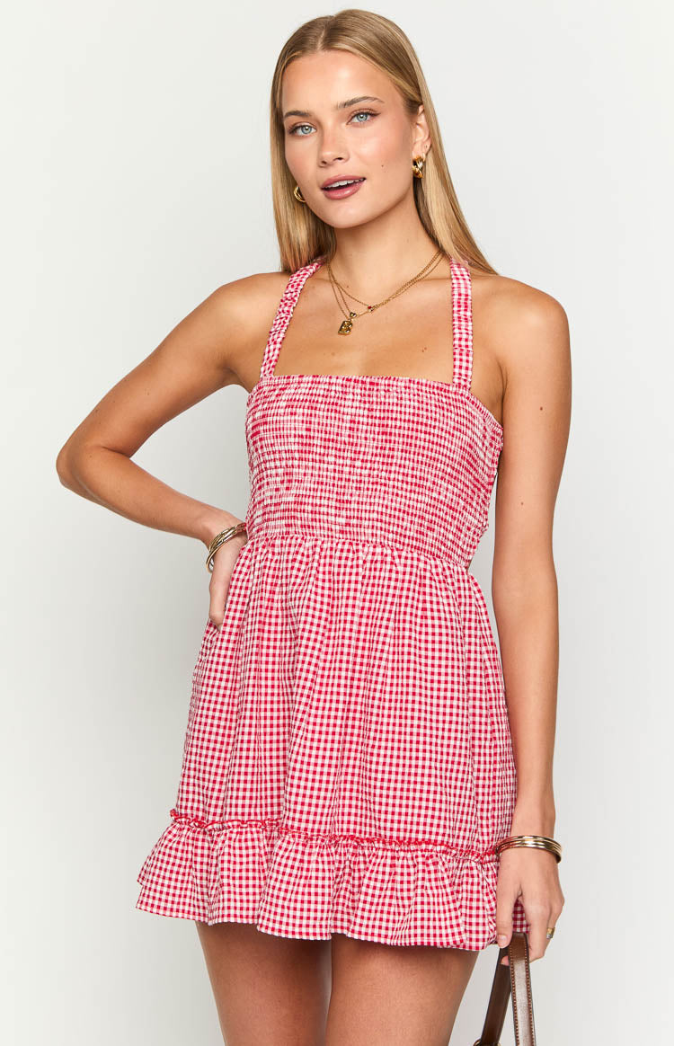 Close-up of the red gingham mini dress showing the shirred bodice, square neckline, and ruffled hem