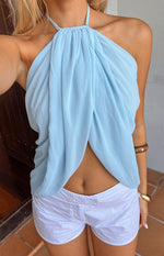 Close-up of the light blue chiffon halter top with a draped wrap-style front and exposed midriff