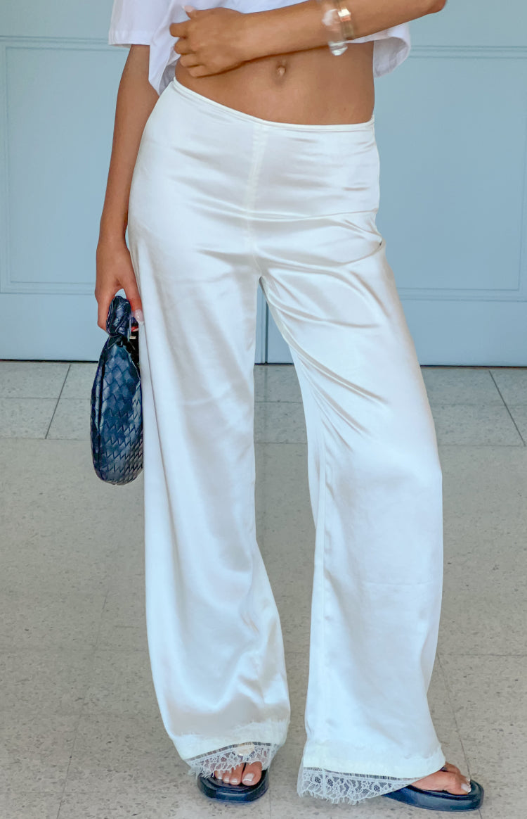 Ivory satin straight leg pants with a delicate lace trim at the hem