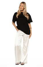 Ivory satin straight leg pants with delicate lace trim at the hem