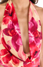 Close-up of the draped cowl neckline of a yellow top with red and pink orchid print
