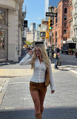 Tan suedette shorts with a fitted short length and visible texture