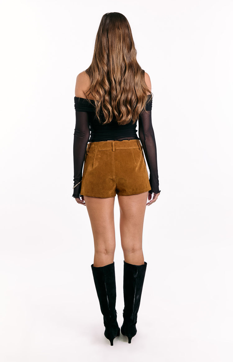 Rear view of tan suedette shorts with belt loops and a subtle back pleat
