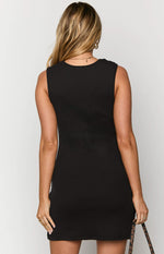 Rear view of a black ribbed knit mini dress with a high scoop back