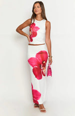 Upper portion of a fitted white maxi skirt with a large vibrant pink orchid print