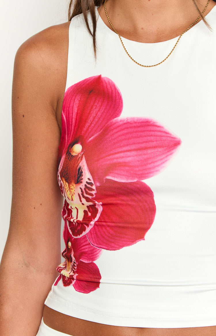 Side view of the white top, highlighting the large pink orchid print and fitted silhouette