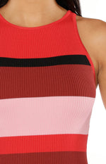 Close-up of the ribbed knit fabric with red, black, dark pink, and light pink horizontal stripes and a high crew neckline