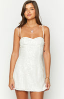 Beginning Boutique Penny Lane White Sequin Mini Dress white sequin mini dress with sweetheart neckline and tie-up spaghetti straps