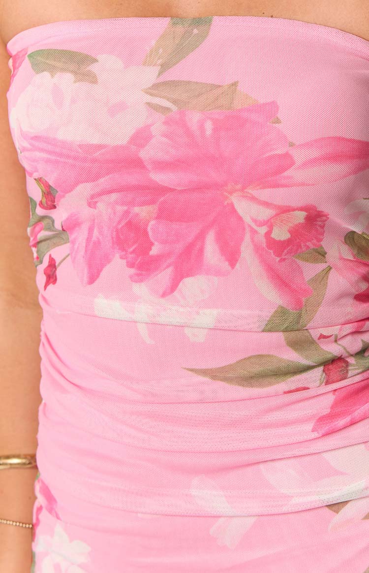 Close-up of the pink floral mesh fabric with large pink flowers and ruched side detail on the mini dress