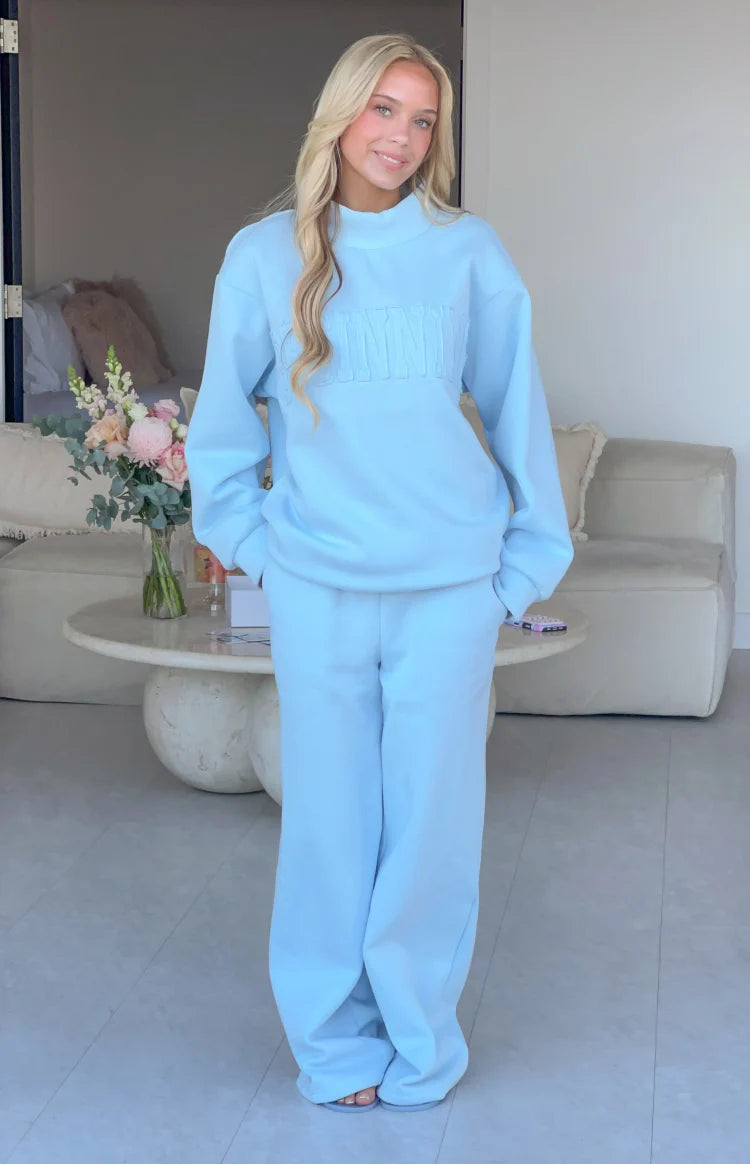 Full length view of light blue mid-rise slouch fit trackpants with a wide leg
