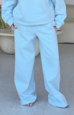 Full length view of light blue mid-rise slouch fit trackpants with a wide leg and soft fabric