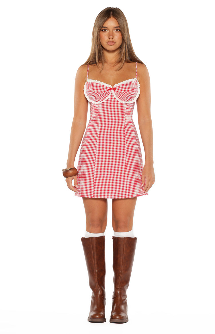 Front view of a red gingham mini dress with a sweetheart neckline, white lace trim, and a small red bow