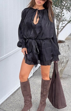 Black satin mini dress with a deep V-neck, long billowy sleeves, tie waist, and tiered ruffle skirt