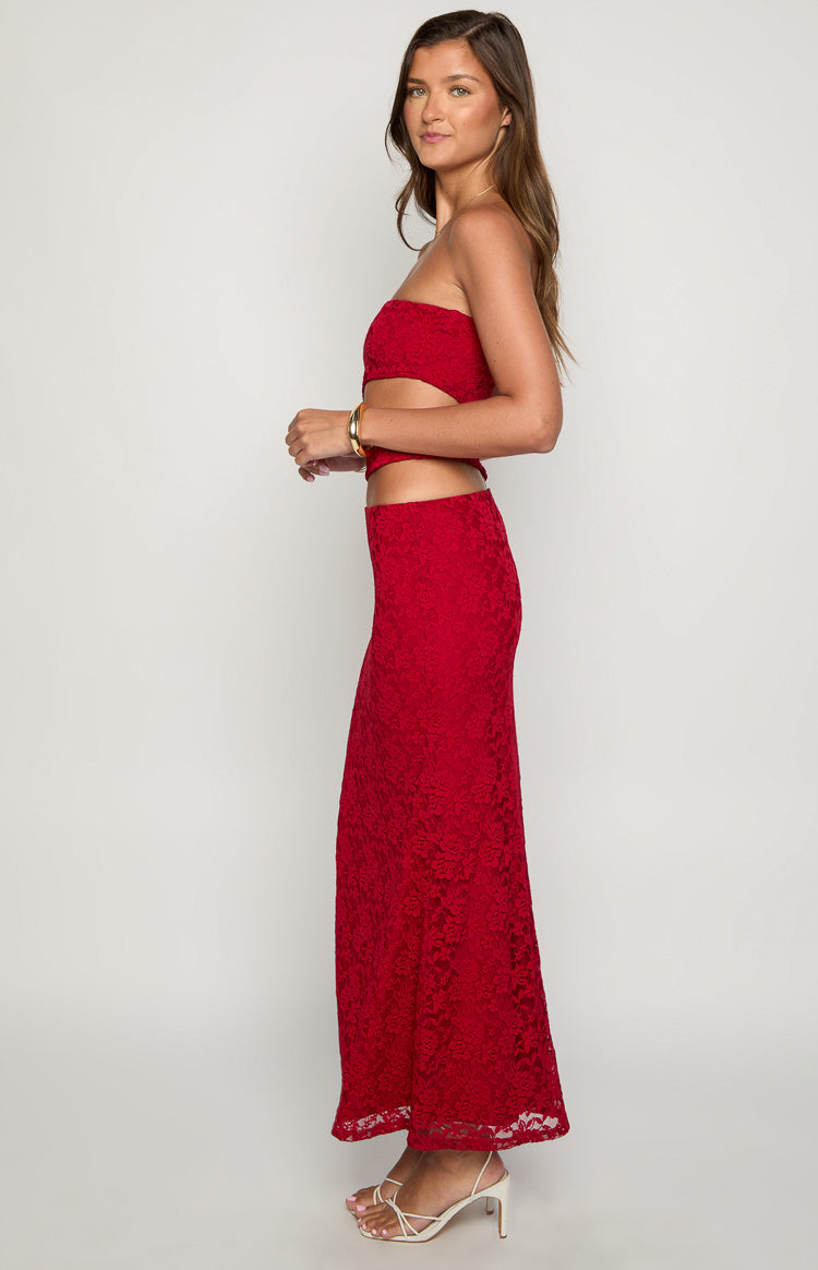 Side view of a red lace strapless maxi dress with a cutout detail at the waist